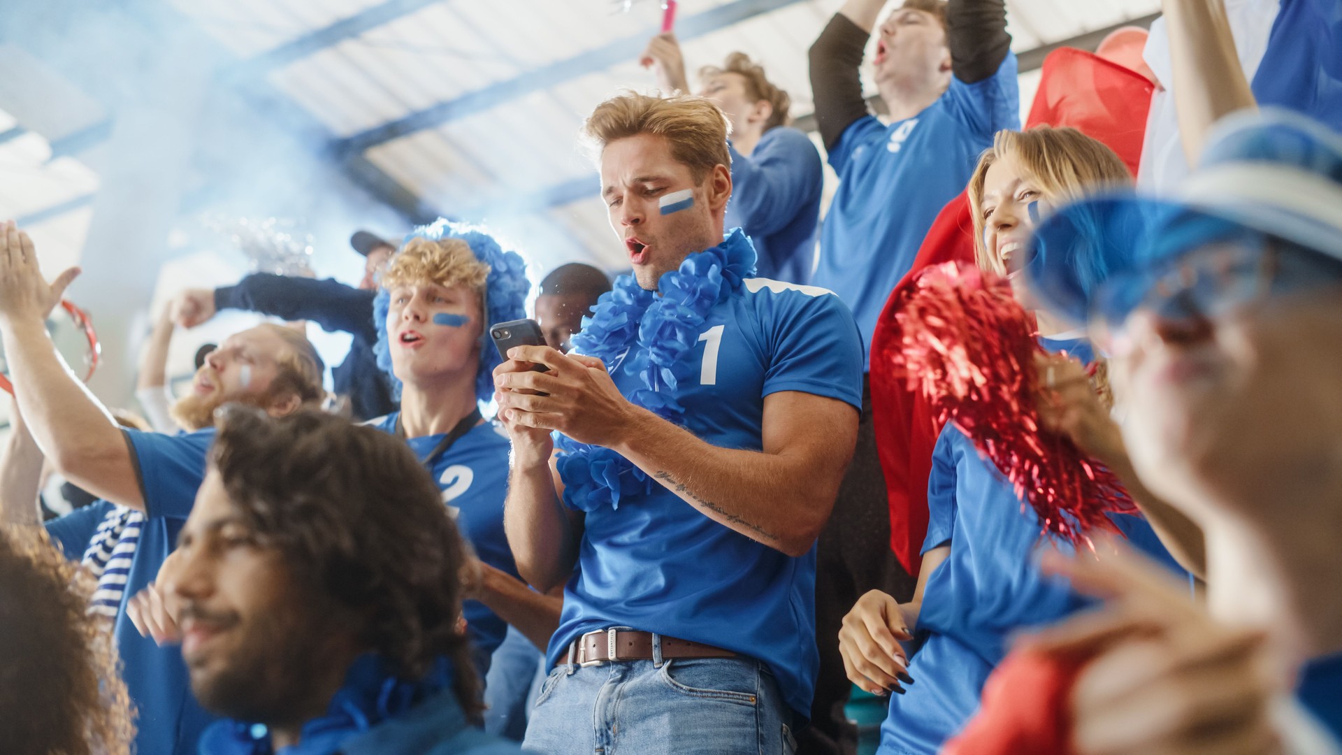 Sport Stadium Soccer Match: Portrait of Excited Caucasian Couple Cheering Team to Win, Use Smartphone to Check App, Bet, Score, Winnings. Crowd Celebrate Goal, Championship Victory